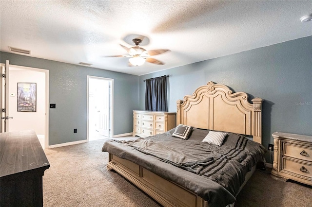 bedroom featuring carpet flooring, a textured ceiling, and ceiling fan