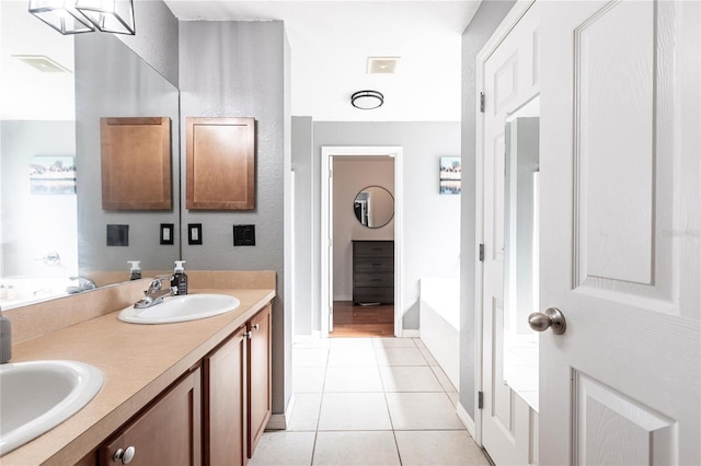 bathroom with vanity, a tub to relax in, and tile patterned floors