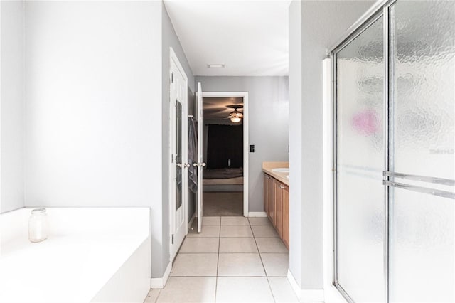 bathroom featuring shower with separate bathtub, tile patterned floors, and vanity