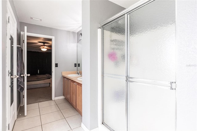 bathroom with an enclosed shower, vanity, and tile patterned floors