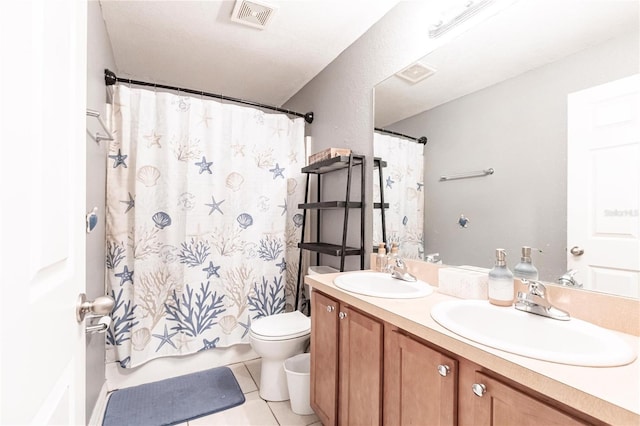 bathroom with vanity, a textured ceiling, curtained shower, tile patterned floors, and toilet