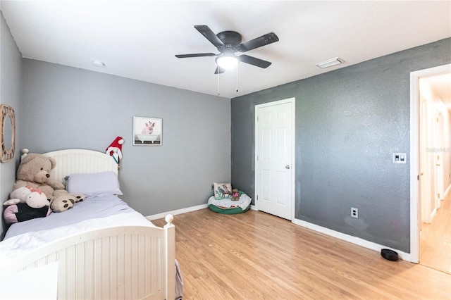 bedroom with hardwood / wood-style floors and ceiling fan