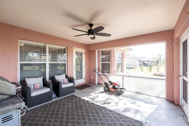 sunroom / solarium featuring ceiling fan