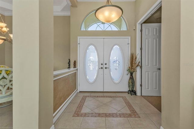 tiled entrance foyer with a notable chandelier