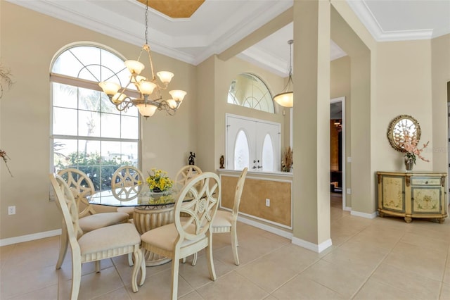 dining room featuring light tile patterned flooring, ornamental molding, and an inviting chandelier