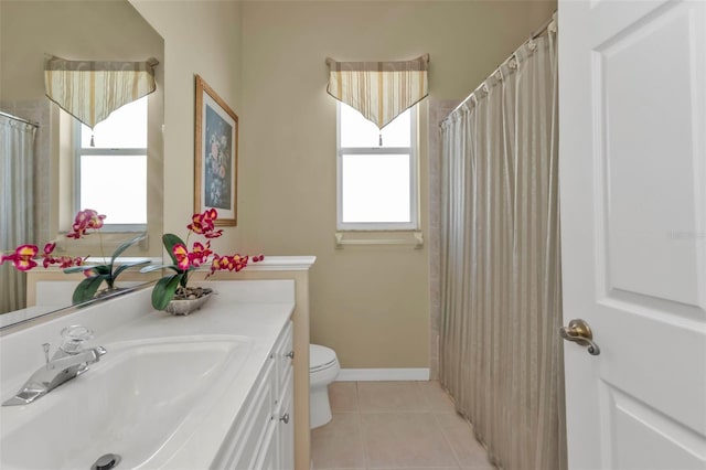 bathroom featuring vanity, tile patterned floors, and toilet