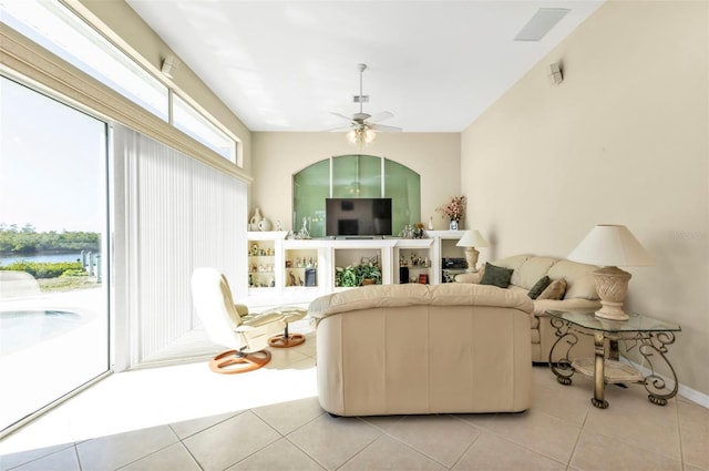 tiled living room with ceiling fan