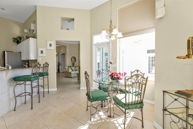 dining room featuring an inviting chandelier and light tile patterned floors