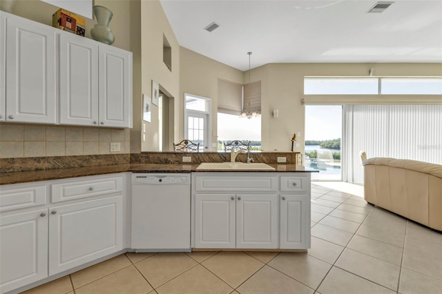 kitchen with white cabinetry, white dishwasher, and sink