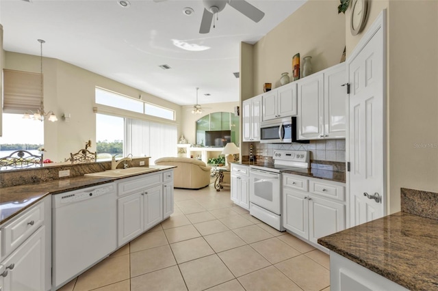 kitchen with white cabinetry, white appliances, sink, and hanging light fixtures