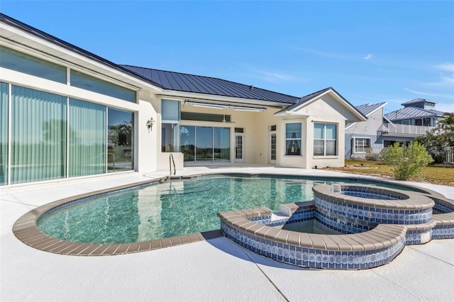 view of pool with an in ground hot tub and a patio area