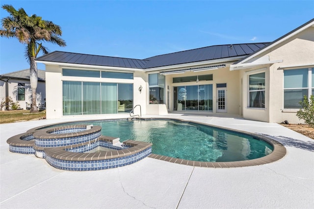 view of pool featuring a patio area and an in ground hot tub