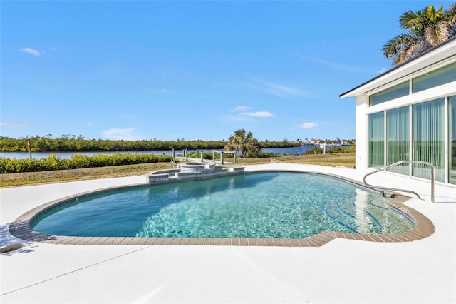 view of swimming pool featuring a patio area and an in ground hot tub