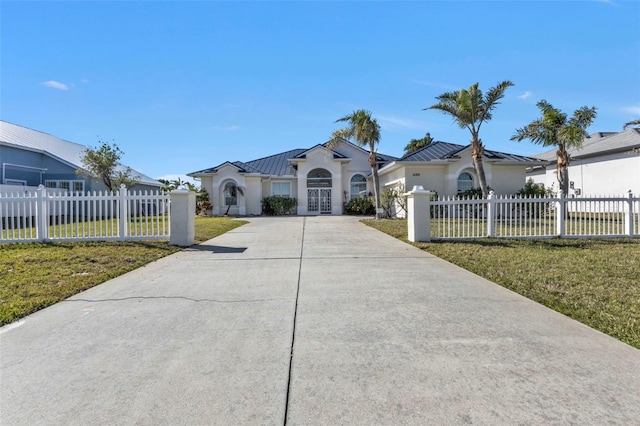 ranch-style home with french doors and a front yard