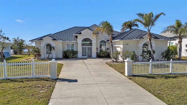 view of front facade featuring a front yard and french doors