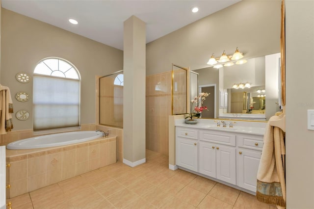 bathroom featuring shower with separate bathtub, tile patterned floors, and vanity