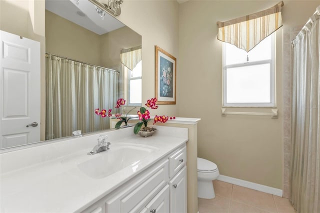 bathroom featuring tile patterned flooring, vanity, and toilet