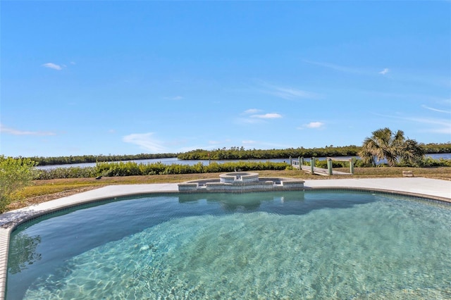 view of swimming pool with an in ground hot tub