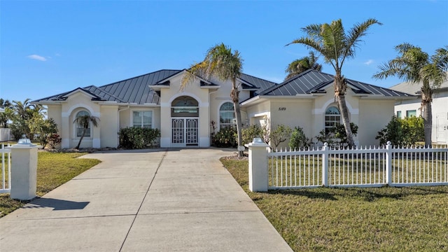 view of front of house featuring french doors and a front lawn