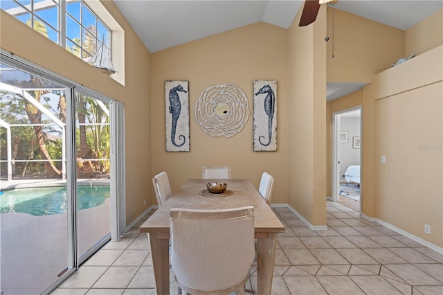 tiled dining room with ceiling fan and high vaulted ceiling