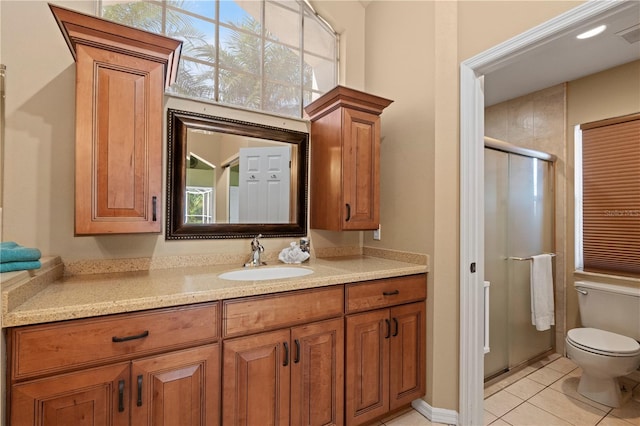 bathroom featuring walk in shower, tile patterned floors, vanity, and toilet