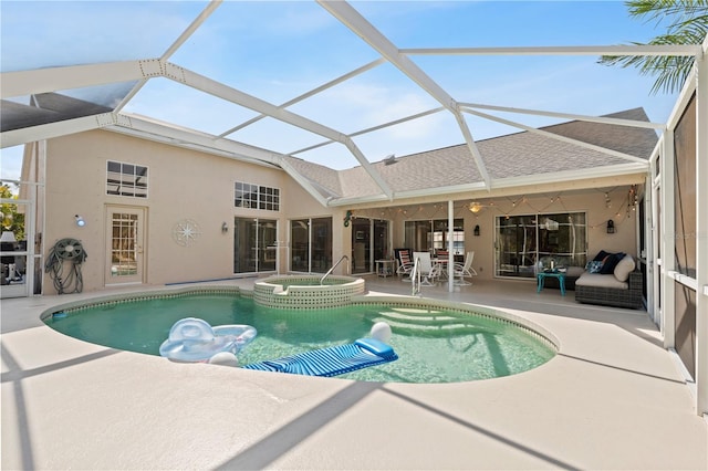 view of pool featuring an in ground hot tub, a lanai, and a patio area