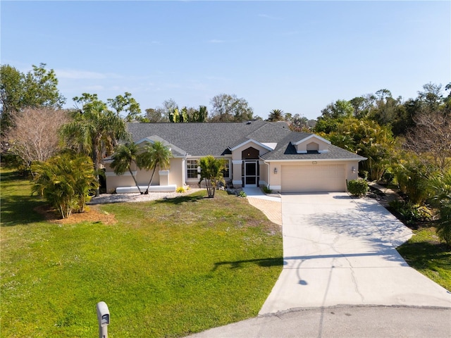 ranch-style house with a garage and a front lawn