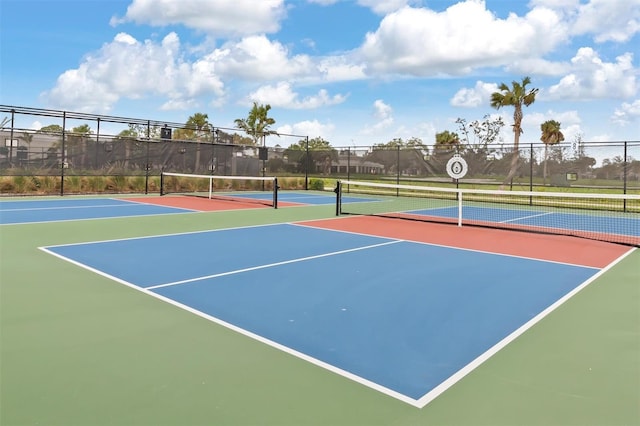 view of tennis court featuring basketball hoop