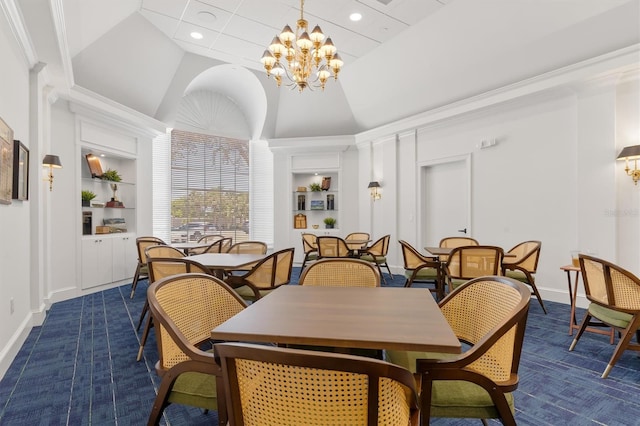 dining room with ornamental molding, high vaulted ceiling, an inviting chandelier, and built in shelves