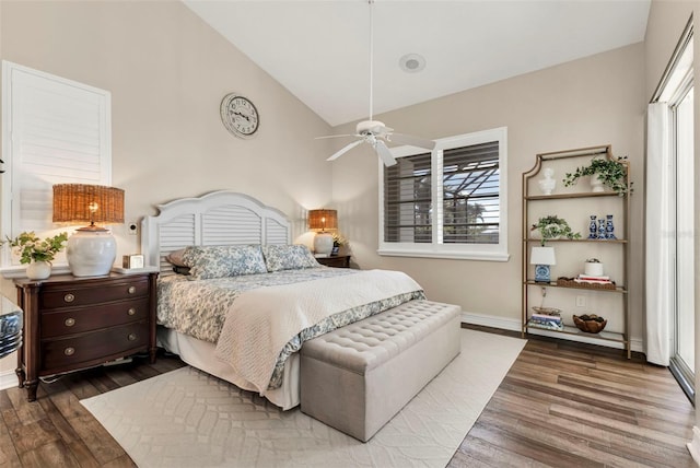 bedroom with multiple windows, wood-type flooring, high vaulted ceiling, and ceiling fan