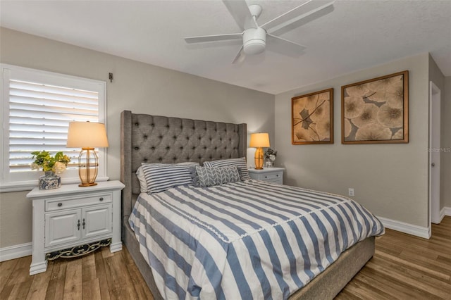 bedroom featuring dark hardwood / wood-style floors and ceiling fan