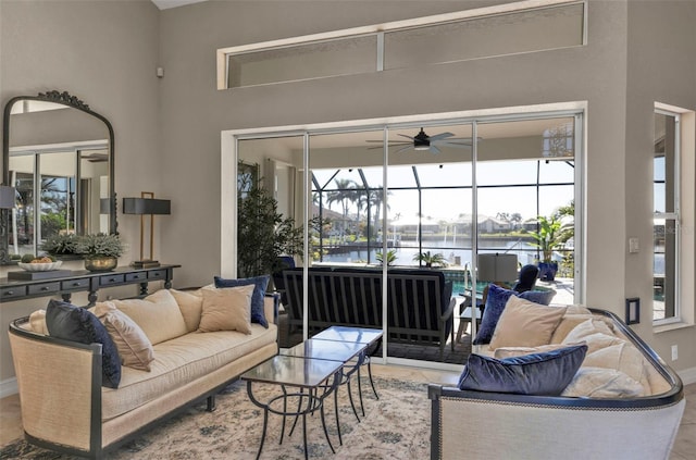 living room featuring a water view and ceiling fan