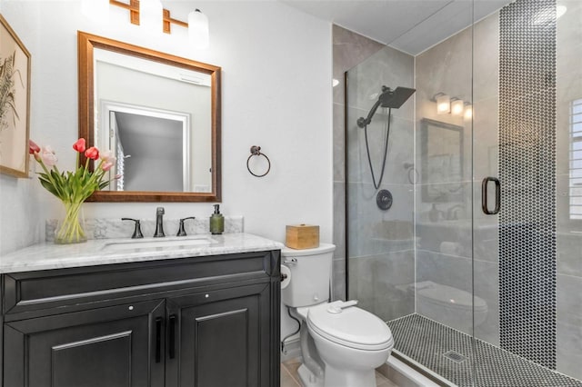 bathroom featuring vanity, toilet, and walk in shower