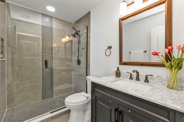 bathroom featuring vanity, a shower with door, and toilet