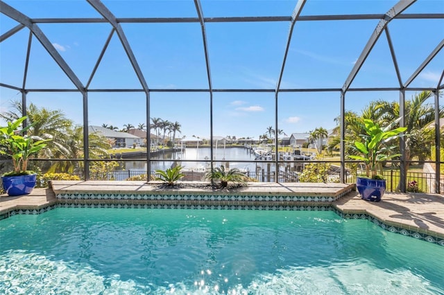 view of swimming pool featuring a water view, a patio, and a lanai