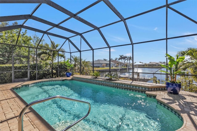 view of swimming pool with a lanai, a patio area, and a water view