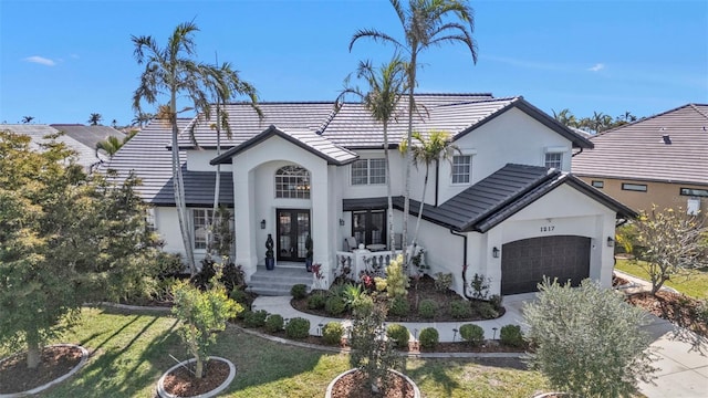 view of front of property featuring a garage and a front lawn