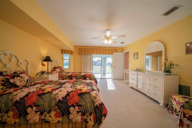 carpeted bedroom featuring access to exterior and ceiling fan