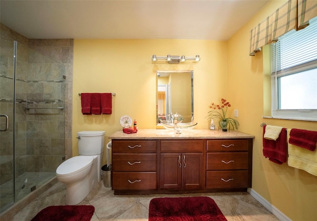 bathroom featuring vanity, toilet, and walk in shower