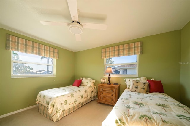 bedroom with ceiling fan and light carpet