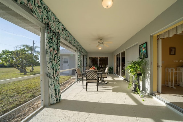 sunroom with a healthy amount of sunlight and ceiling fan