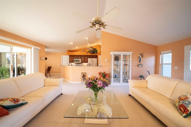 carpeted living room featuring ceiling fan, vaulted ceiling, and a healthy amount of sunlight