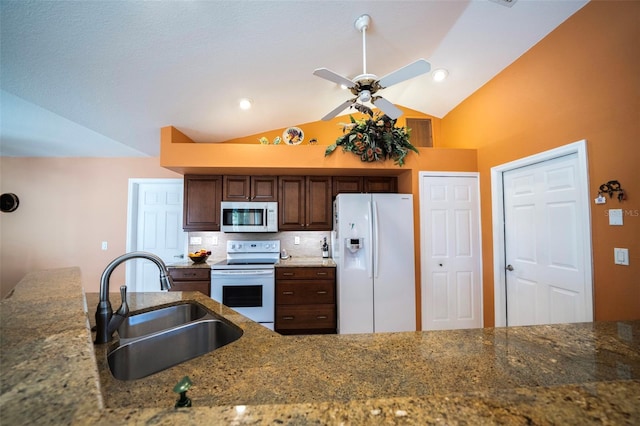 kitchen with vaulted ceiling, sink, backsplash, ceiling fan, and white appliances