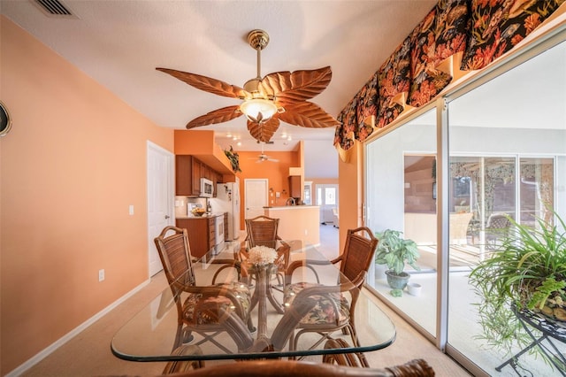 dining room featuring light carpet and ceiling fan