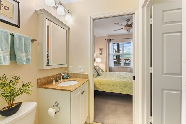 bathroom featuring vanity, ceiling fan, and toilet