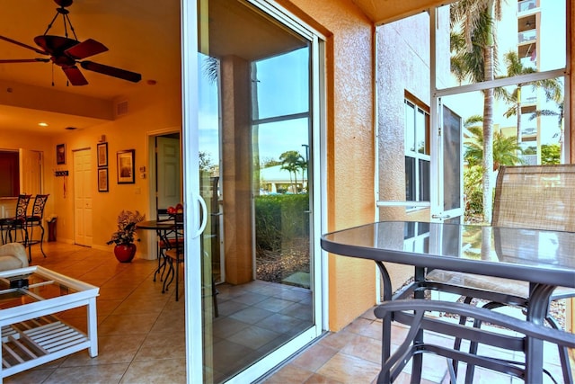 sunroom featuring ceiling fan