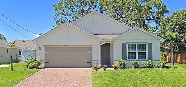 view of front of property featuring a garage and a front lawn