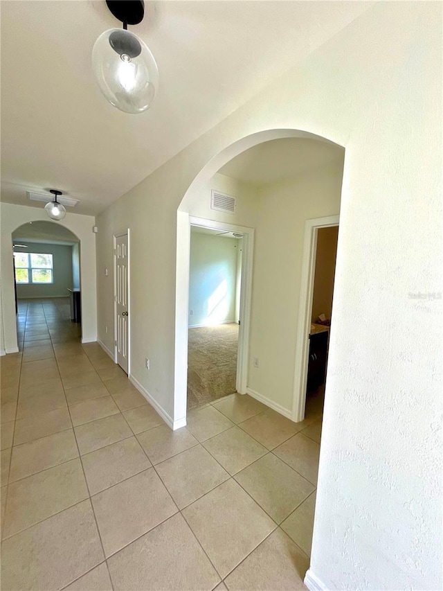 hallway featuring light tile patterned flooring