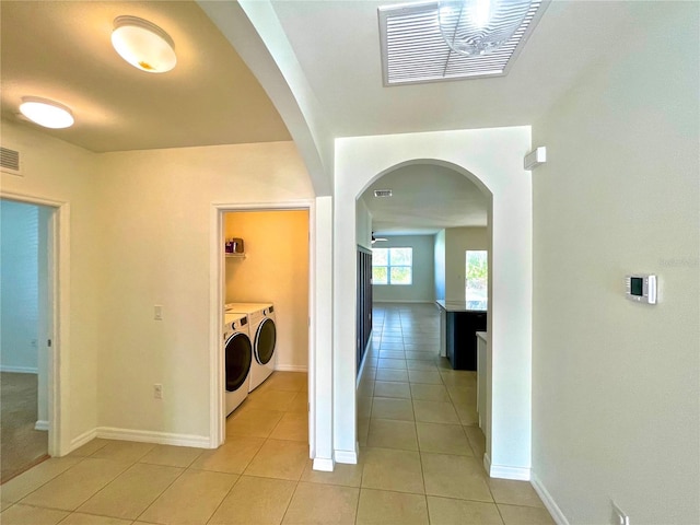 washroom with independent washer and dryer and light tile patterned floors