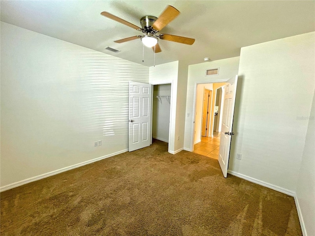 unfurnished bedroom with a closet, ceiling fan, and carpet flooring